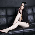 Icon beautiful young woman in bodysuit with long legs sitting 503519784 1258x838